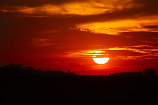 Setting sun in cloudy sky