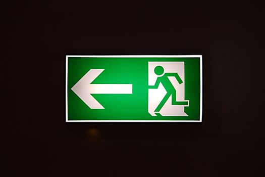 Emergency exit sign glowing in the dark