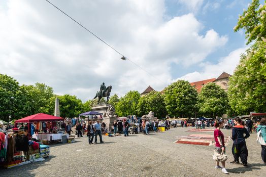 STUTTGART, GERMANY - APRIL 26, 2014: Visitors of the famous Stuttgart flea market on Karlsplatz in the city center on April, 26, 2014 in Stuttgart, Germany. The flea market is held every Saturday and attracting both private and commercial sellers and buyers from Stuttgart and abroad.