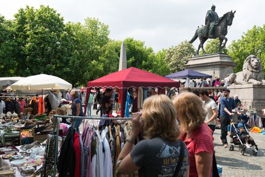 STUTTGART, GERMANY - APRIL 26, 2014: Visitors of the famous Stuttgart flea market on Karlsplatz in the city center on April, 26, 2014 in Stuttgart, Germany. The flea market is held every Saturday and attracting both private and commercial sellers and buyers from Stuttgart and abroad.