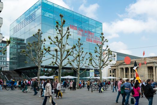 STUTTGART, GERMANY - APRIL 26, 2014: People are passing the new art museum in city center of Stuttgart on April, 26, 2014 in Stuttgart, Germany. The art museum is currently showing the works of GEGO (Gertrud Goldschmidt) and Luisa Richter, both born Germans that moved to Caracas and are famous for their art works there and all over Latin America.