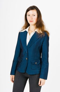 Young serious woman in blue jacket standing