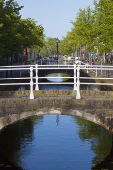 bridge over canal with reflection and trees