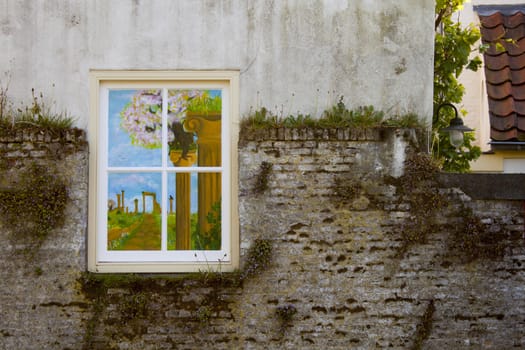 painted window on stone wall with moss