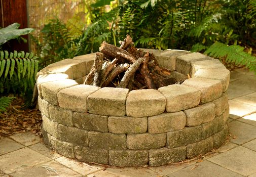 stone fire pit with bricks in the backyard