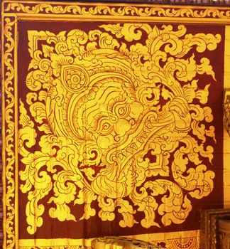 detail of thai pattern that made by covered wood plate with gold leaf for decorated temple door or pillar,shallow focus
