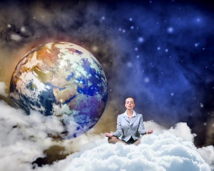 image of a businesswoman meditating in the clouds in space