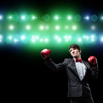 image of a businessman with boxing gloves in the ring, the competition in the business