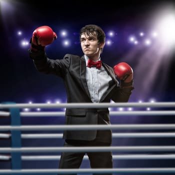 image of a businessman with boxing gloves in the ring, the competition in the business