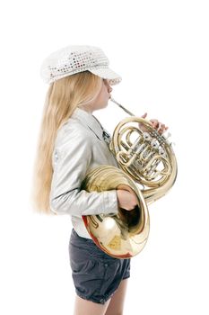 young girl with cap playing french horn against white background