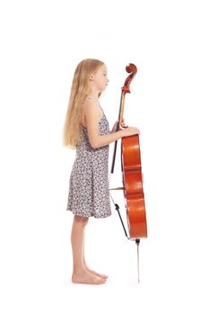 young girl in dress and her cello in studio against white background