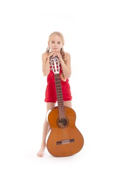 young standing girl standing with guitar against white background