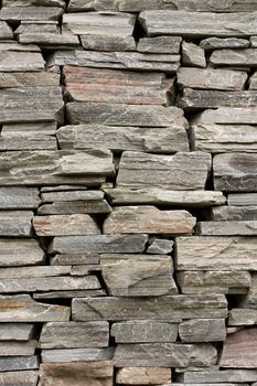 Stone wall constructed from grey schist and slate