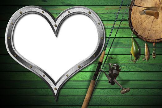 Empty metal porthole heart shape on green wooden wall with fishing tackle, fishing rod and pen knife