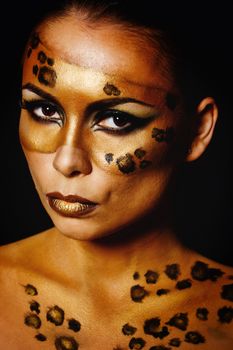 Attractive young girl with makeup wild leopard close-up portrait