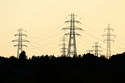 Many electric towers against dusk sky