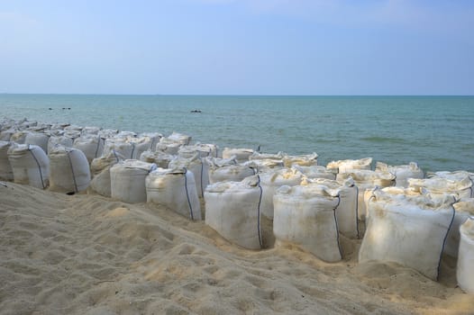 Sand bags along the beach in Songkra to protect from heavy surf and erosion, Thailand.