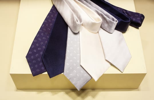 Close up of six elegant neckties on clothes shop