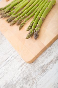 Fresh Asparagus on a wooden tablet.