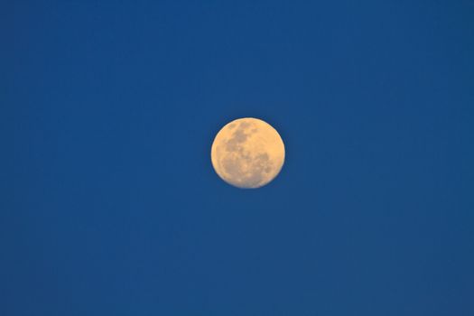 full moon in dark sky during the day