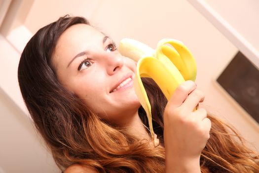 A young woman eating a Banana.