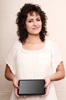 A young woman in a Retro dress holding a Tablet PC.