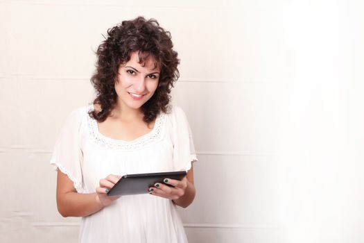 A young woman holding a Tablet PC.