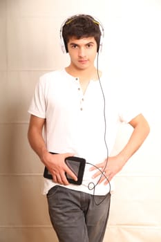 A young, latin man with a Tablet PC and headphones
