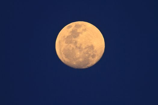 full moon in dark sky during the day