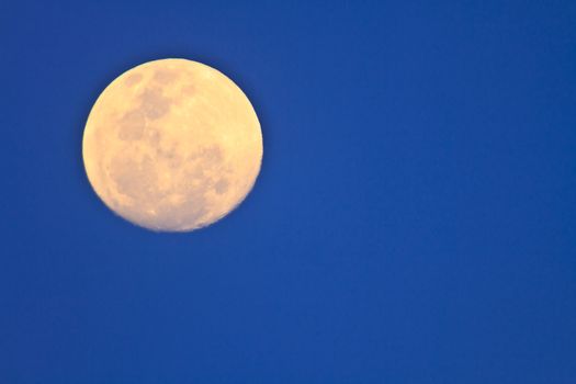 full moon in dark sky during the day