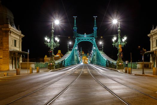 The Freedom bridge in Budapest Hungary by night.