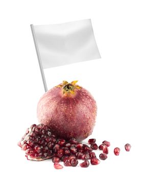 Healthy and organic food concept. Fresh Ripe pomegranate fruit and part with flag showing the benefits or the price of fruits.