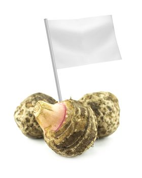 Healthy and organic food concept. Fresh Taro Root with flag showing the benefits or the price of fruits.