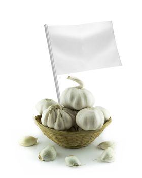 Healthy and organic food concept. Fresh Garlic and garlic bulb with flag showing the benefits or the price of fruits.