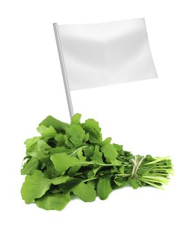 Healthy and organic food concept. Fresh Green Rocket or Roquette leaves with flag showing the benefits or the price of fruits.