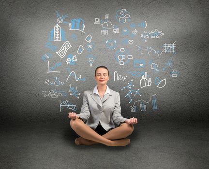 business woman meditating on floor, wall charts and diagrams are drawn