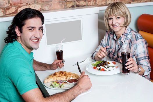 Loving young couple enjoying lunch together