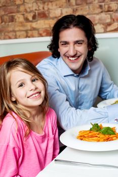 Father dining with his cute little daughter