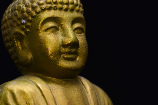 Golden Buddha Statue on a Black Background