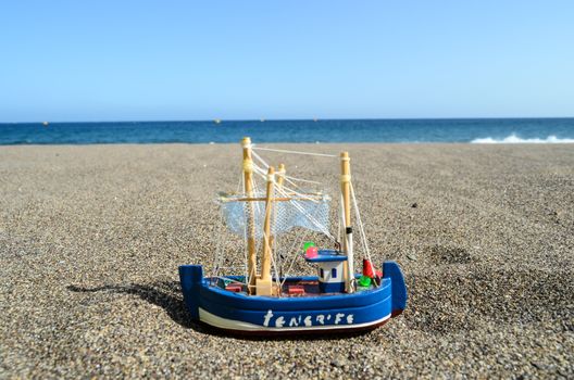 Sail Ship Toy Model in the Beach Sand Close-up