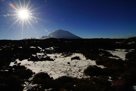 Backlight Sunbeams and Snow on Teide Tenerife Canary Islands