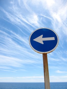 Wndy Clouds and One Way Sign On The Evening Atlantic Ocean Sky