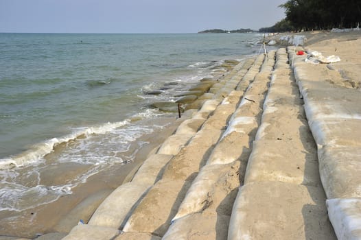 Sand bags along the beach in Songkra to protect from heavy surf and erosion, Thailand.