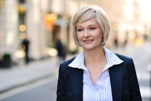 Happy female executive posing at outdoors 