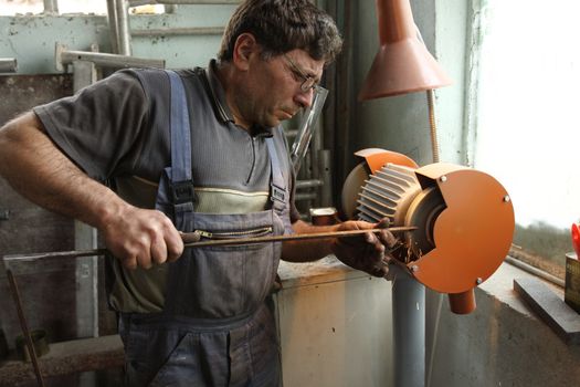 a worker working with a emery