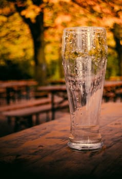 Retro Style Photo Of An Empty Beer Glass On A Beer Garden In Autumn