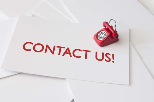 Contact us card with  miniature telephone
