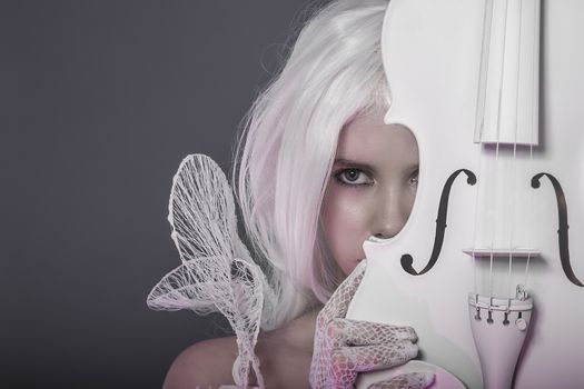 Beautiful girl with white violin