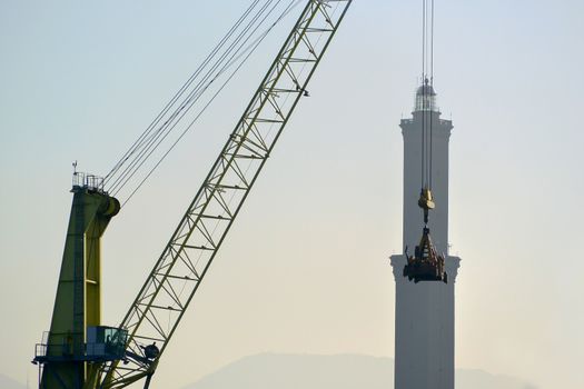 Crane moves contaniers to work in the port of Genoa