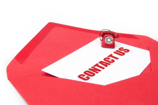 Contact us business card inside an open envelope with a small phone on one side 